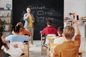 classroom with students and a teacher