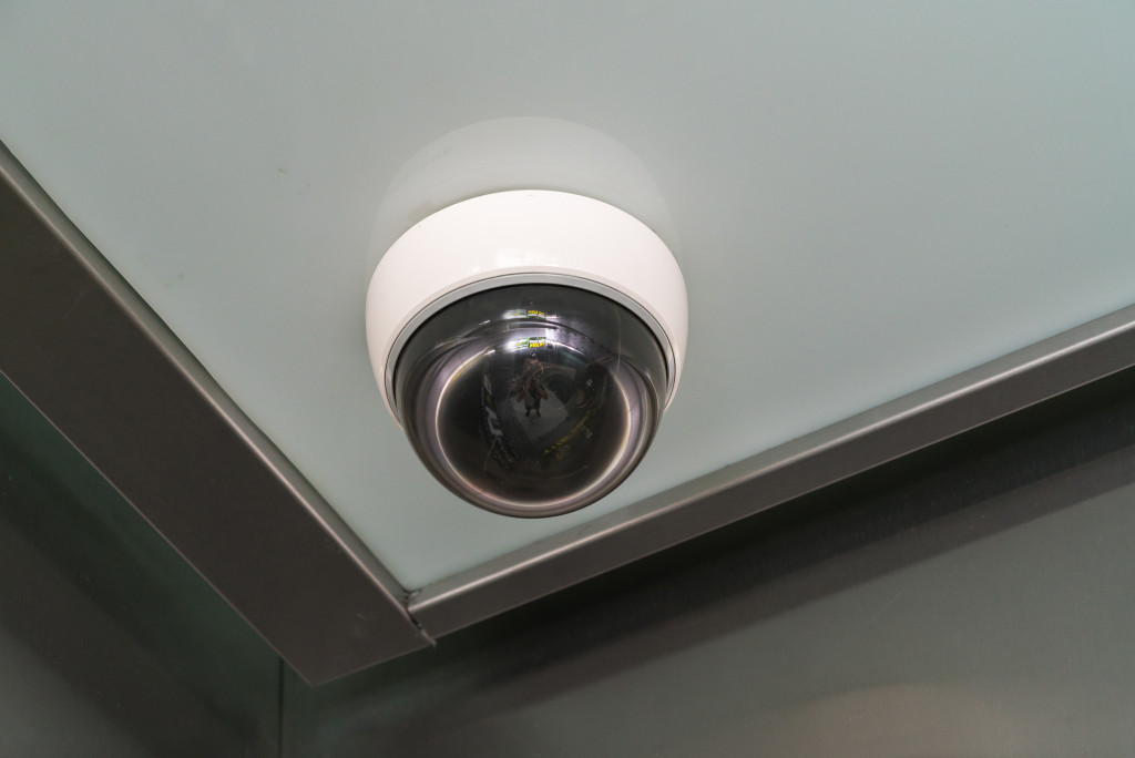A security camera on the corner of a ceiling