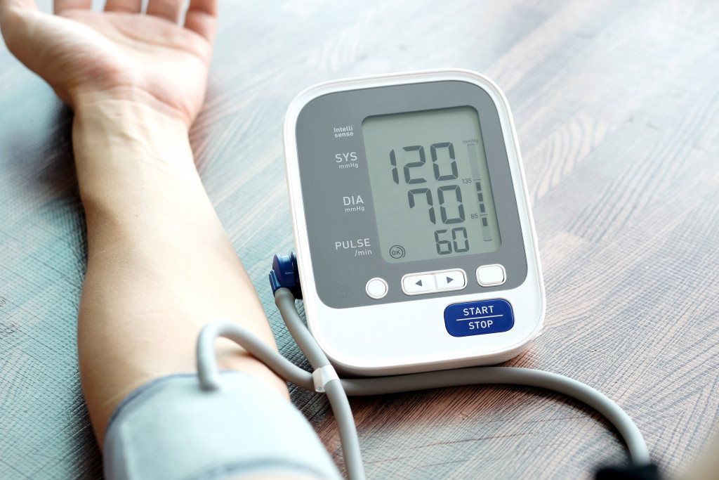 a person using a blood pressure device