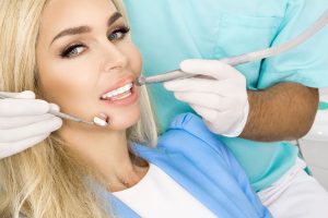 patient's teeth being checked by dentist