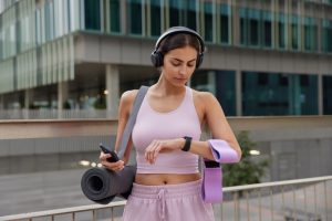 woman using headphones while jogging