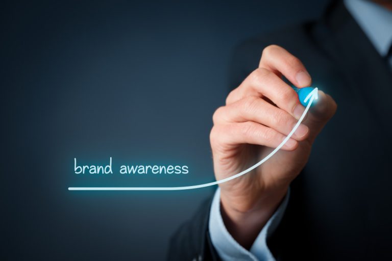 businessman drawing brand awareness with light pen