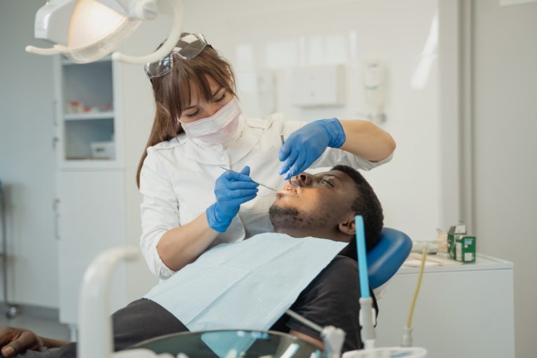 a dentist treating a male patient