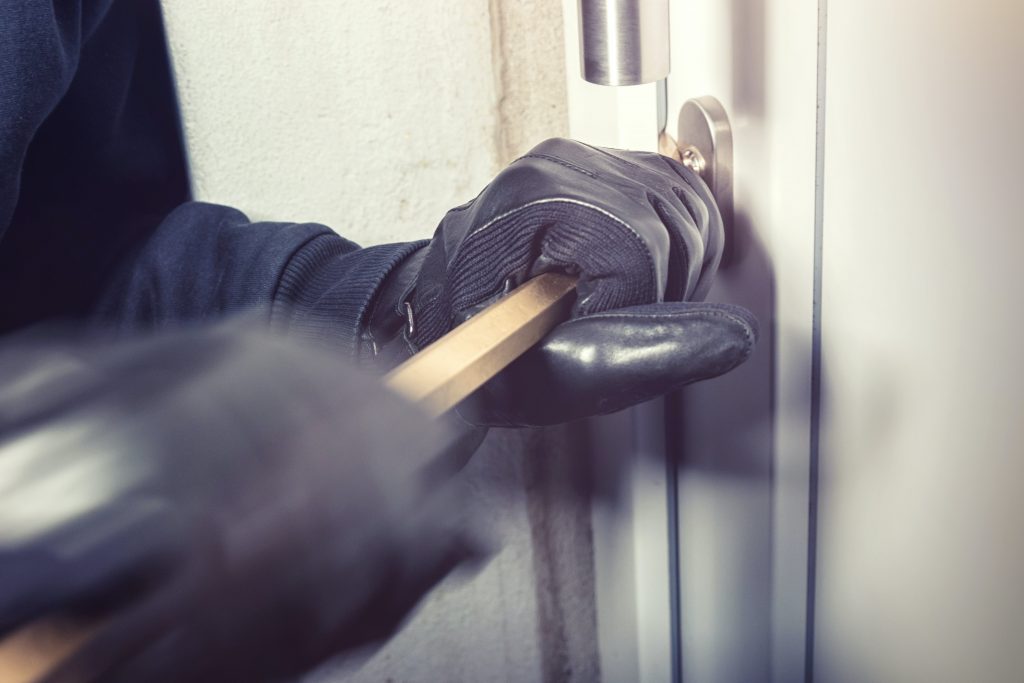 Burglar trying to break into a house